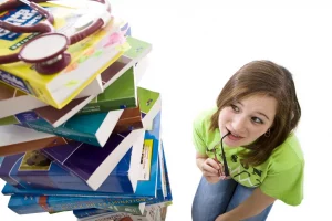 study strategy needed by girl with stack of books